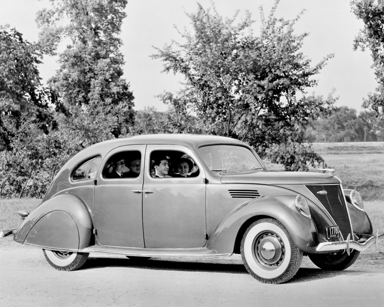 1930s Ford sedan with passengers