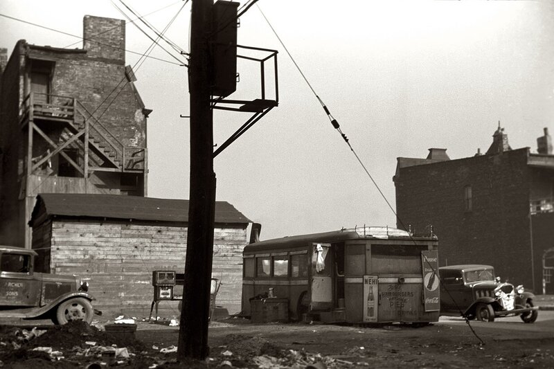 1930s street scene with vintage vehicles