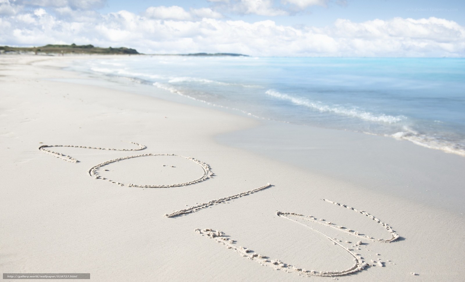 2013 written in sand on beach