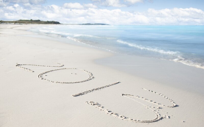 2014 written in sand on a beach