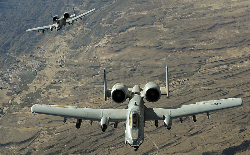 A-10 Thunderbolt II Aircraft — Gray, Dramatic, Afternoon, Photograph, Mountainous Terrain, Town