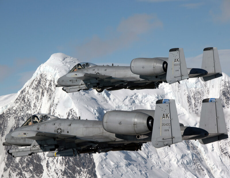A-10 Thunderbolt II jets over snow-capped mountains