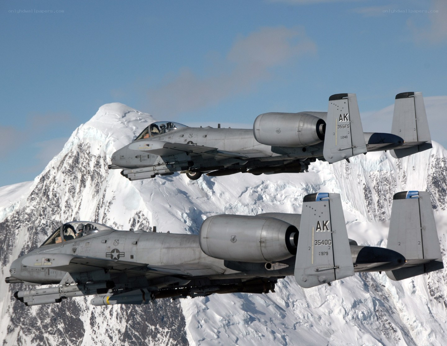 A-10 Thunderbolt II jets over snow-capped mountains