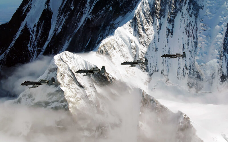 A-10 Thunderbolt II jets over snowy mountains