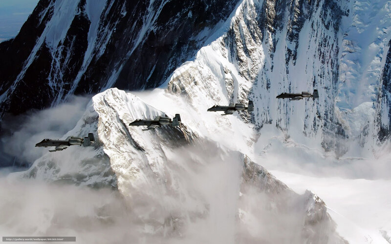 A-10 Thunderbolt II jets over snowy mountains