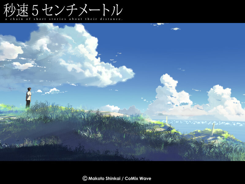 A boy stands on a hill overlooking the sea