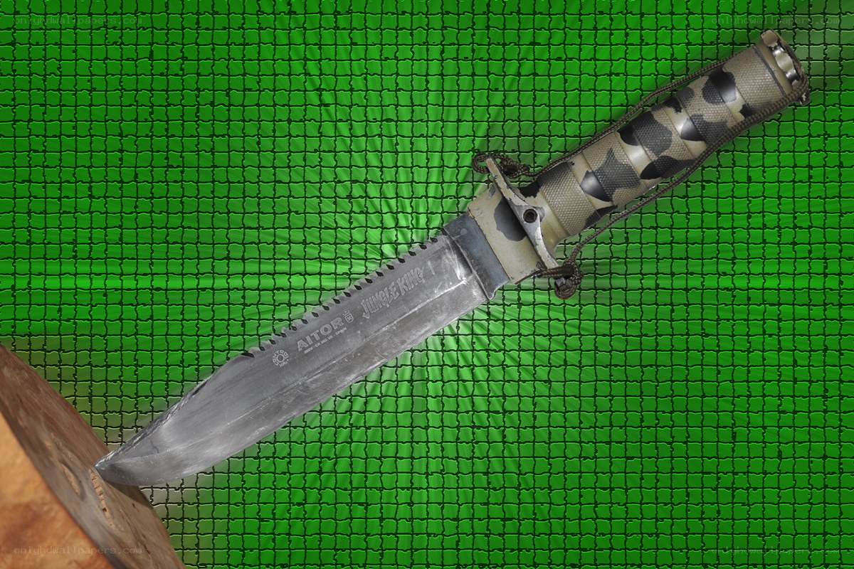 A combat knife on a green mesh