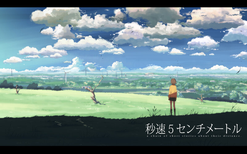 A girl stands in a green field