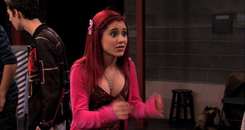 A girl with red hair in a pink sweater