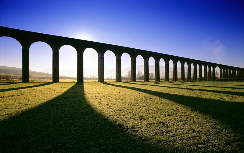 A long stone aqueduct in a field