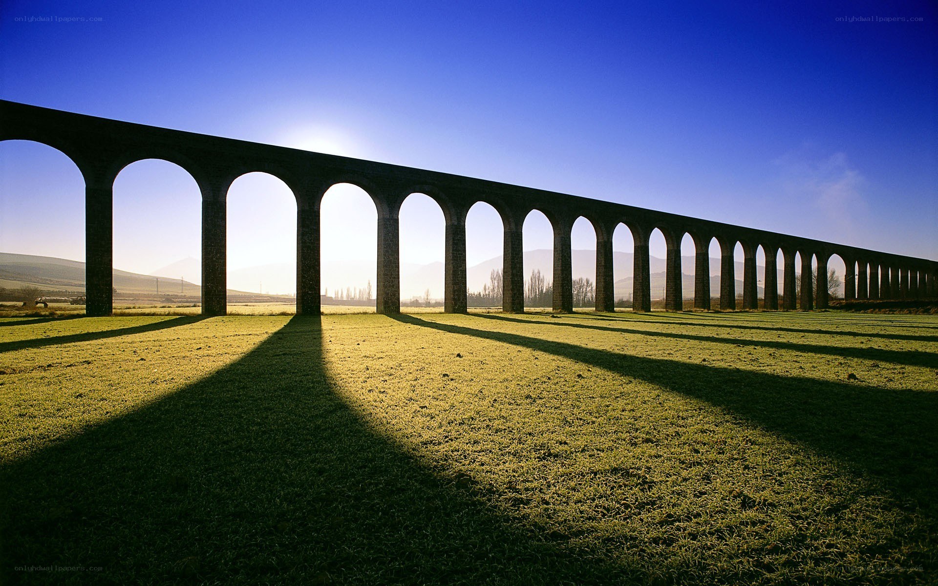 A long stone aqueduct in a field