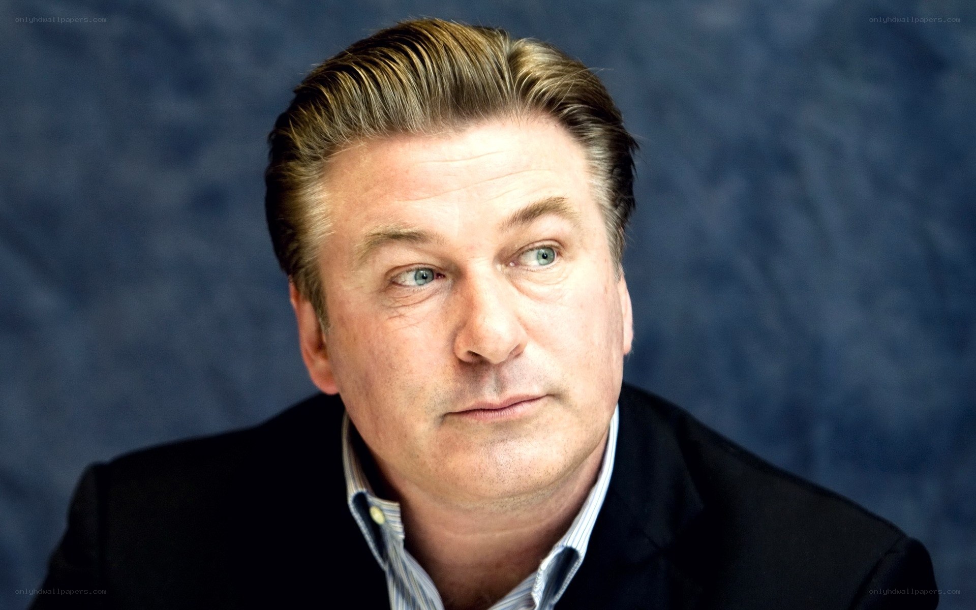 A man in a suit looking away