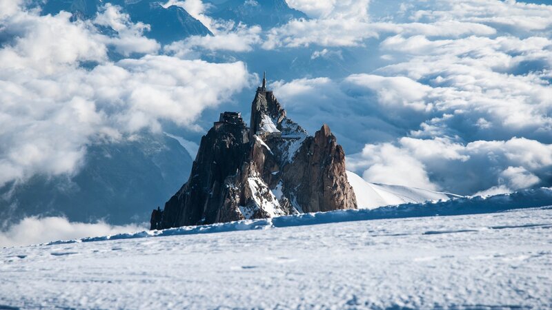 A mountain peak above the clouds