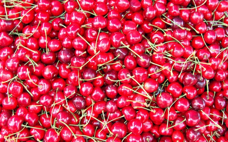 a pile of fresh cherries