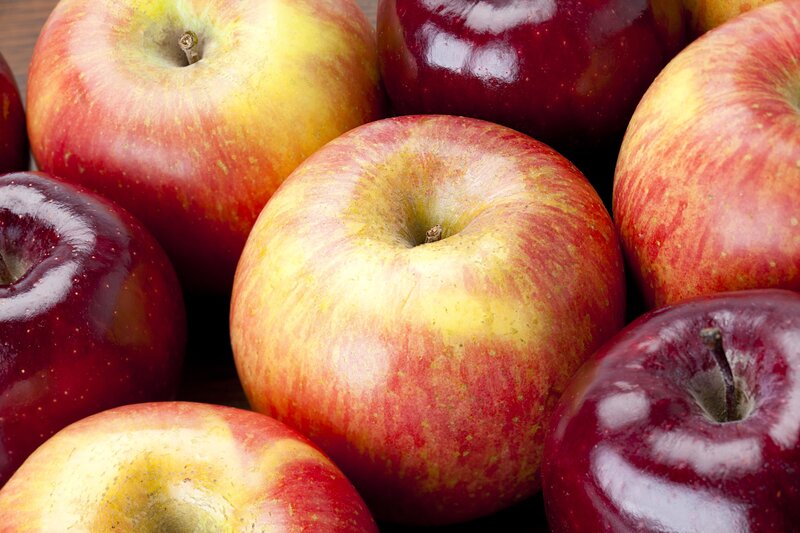 a pile of red and yellow apples