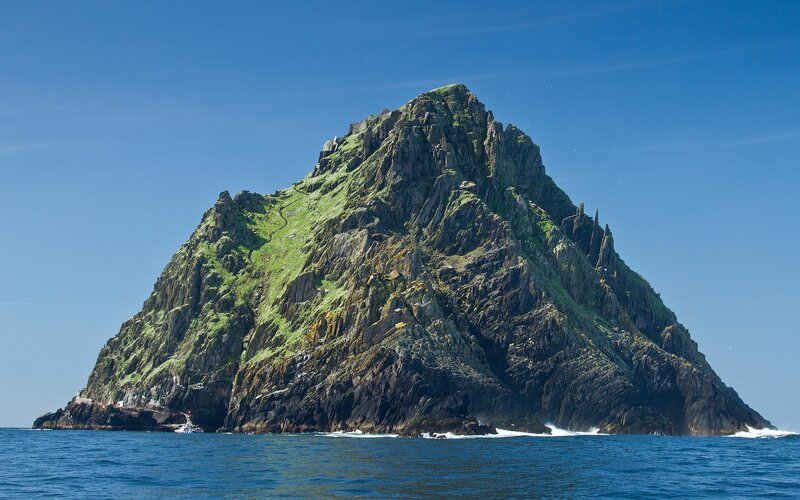 A rugged island rises from the sea