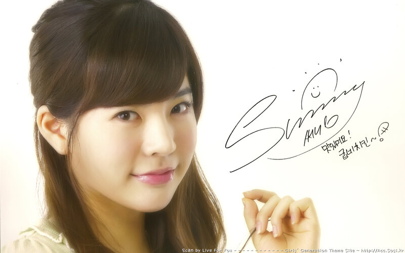 A smiling woman with a signature