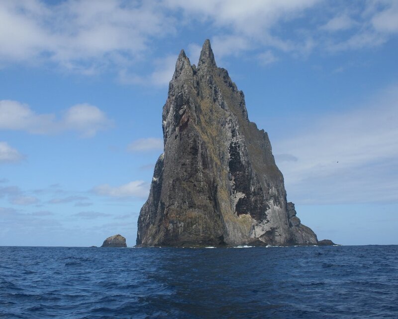 A tall sea stack rises from the ocean