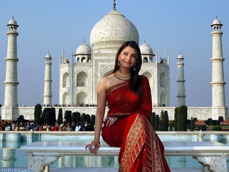 A woman in a red sari at the Taj Mahal