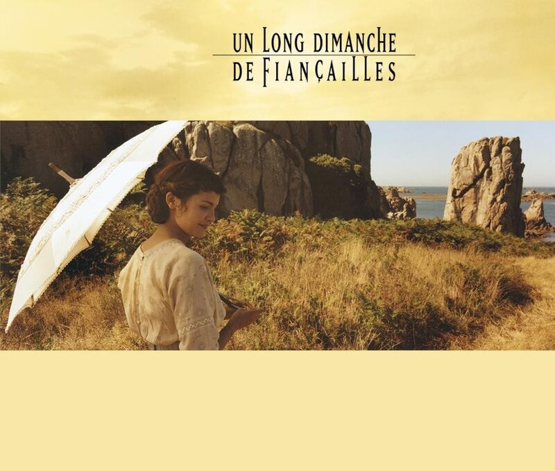 A woman with an umbrella on a cliff