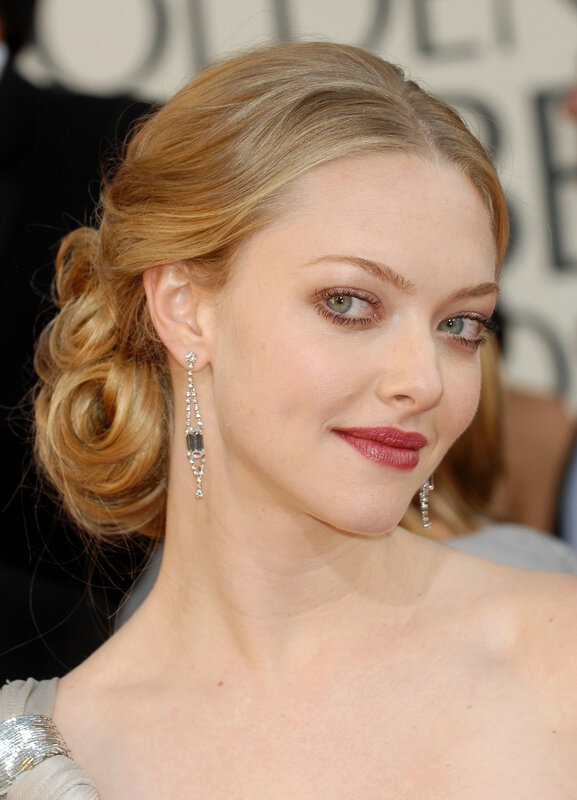 A woman with blonde hair and earrings