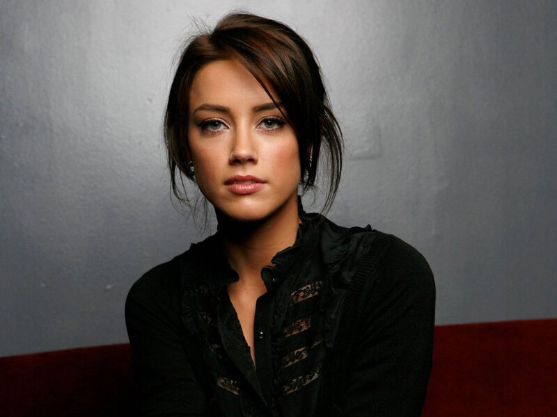 A woman with dark hair and blue eyes