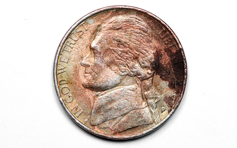 A worn Jefferson nickel coin