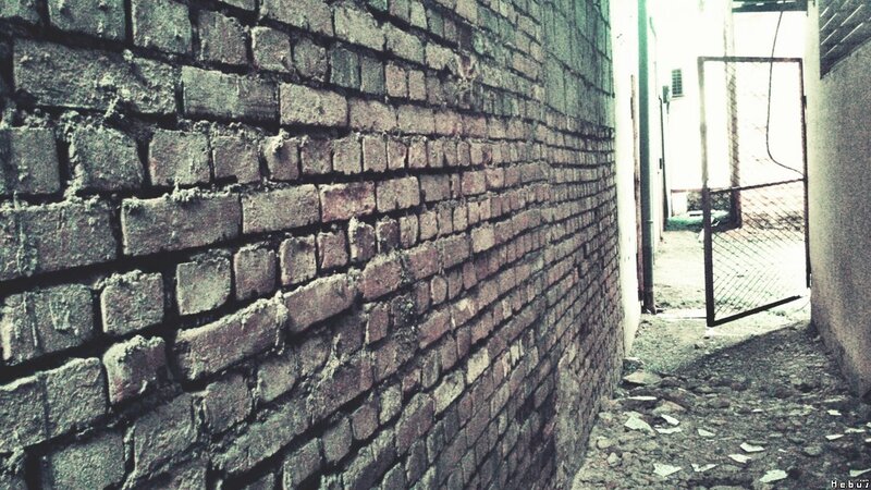 abandoned alley with brick wall
