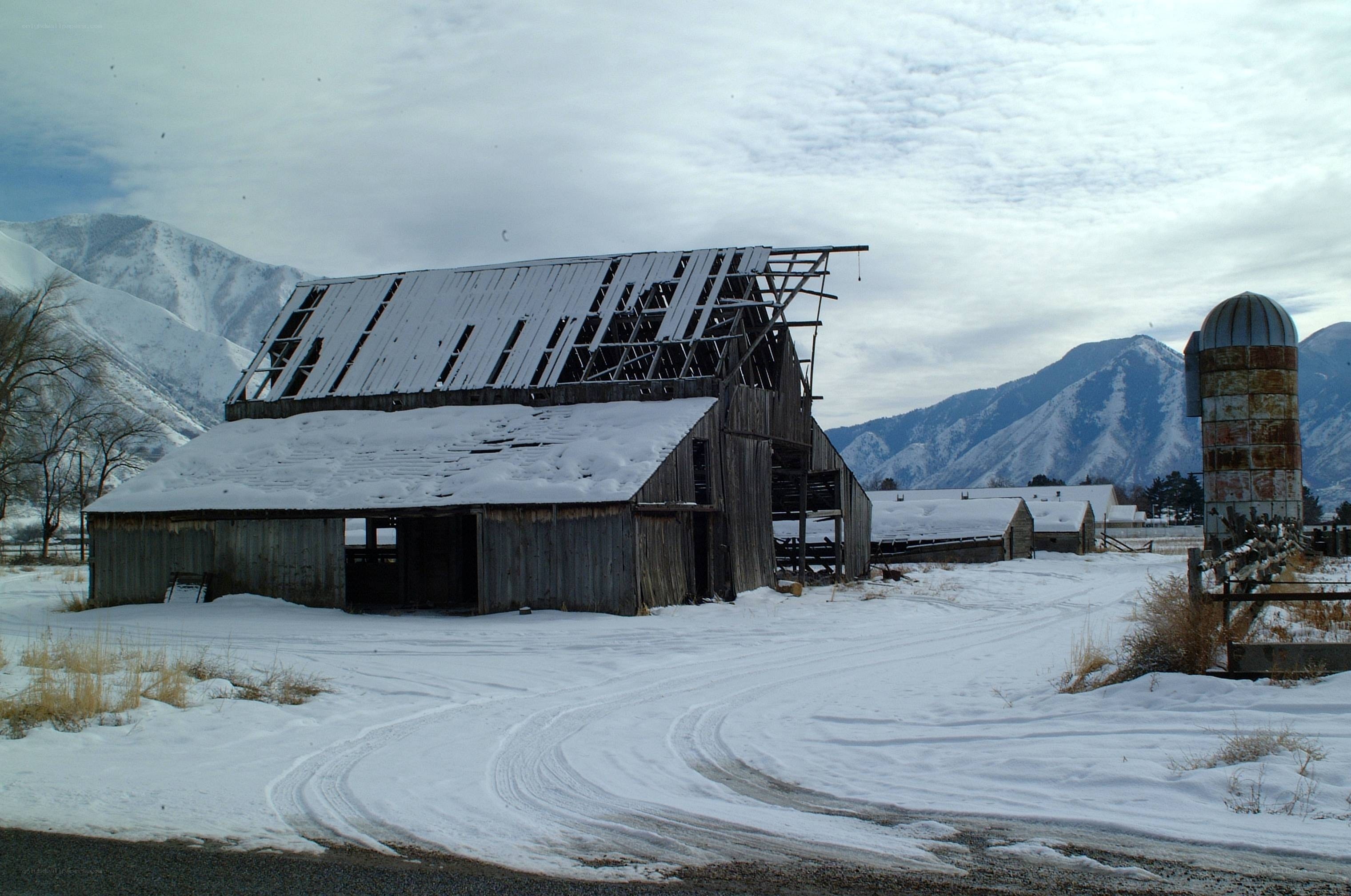 Abandoned barn in snowy mountains