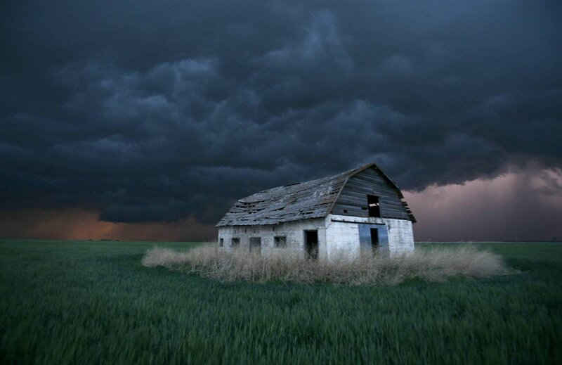 Abandoned barn under stormy sky