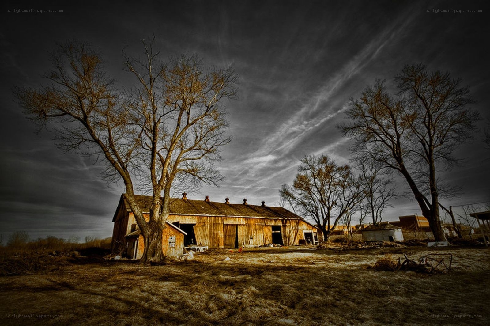 Abandoned barn under stormy sky