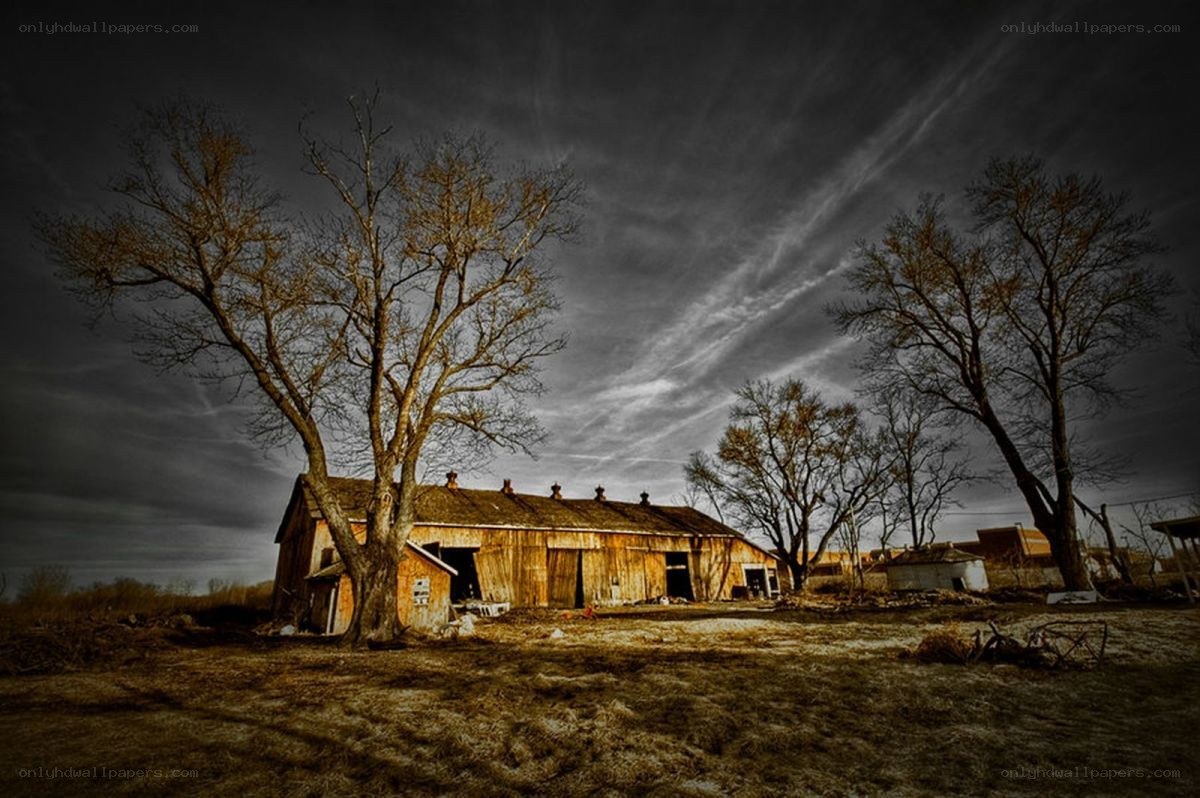 abandoned barn under stormy sky