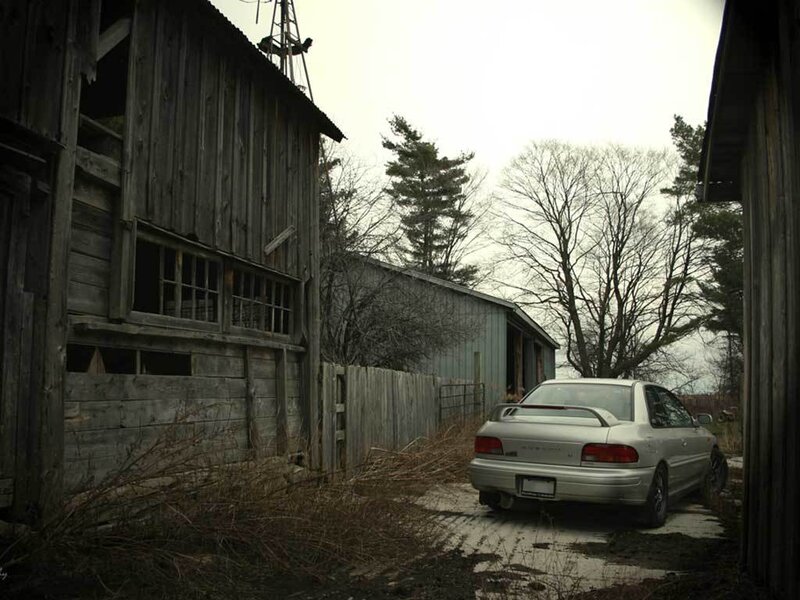 abandoned barn with car