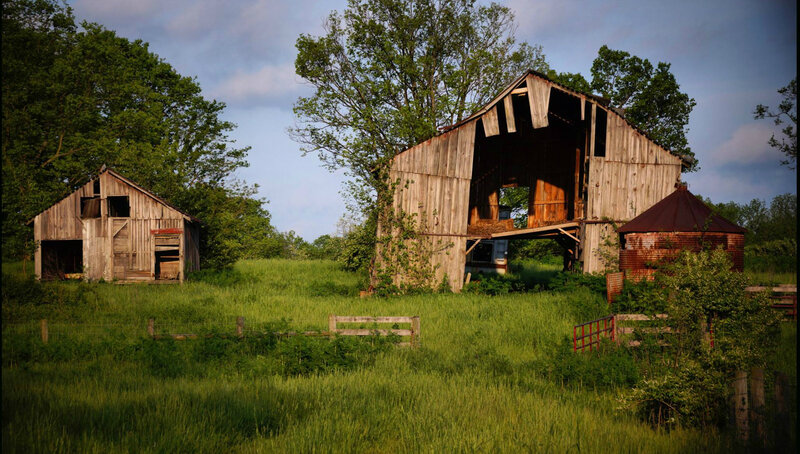 Abandoned Barns in Field