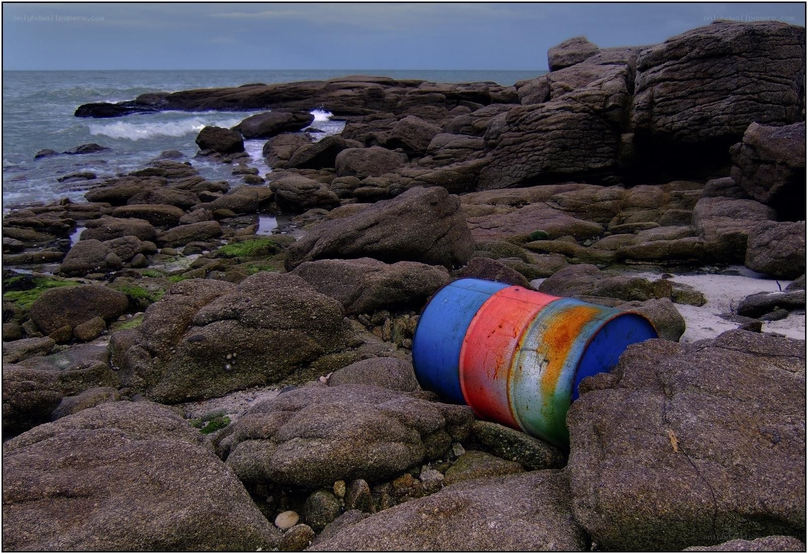 Abandoned barrel on rocky shore