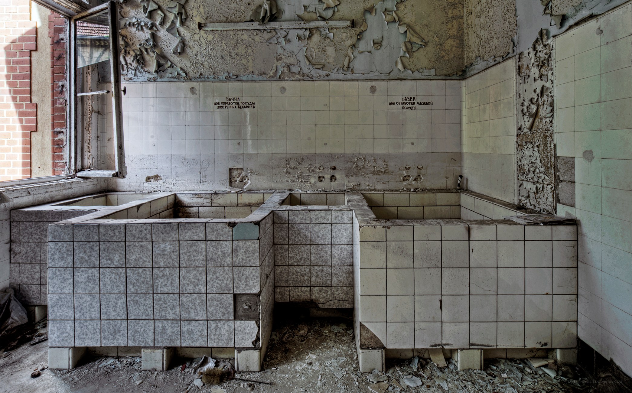 Abandoned bathroom with tiled sinks