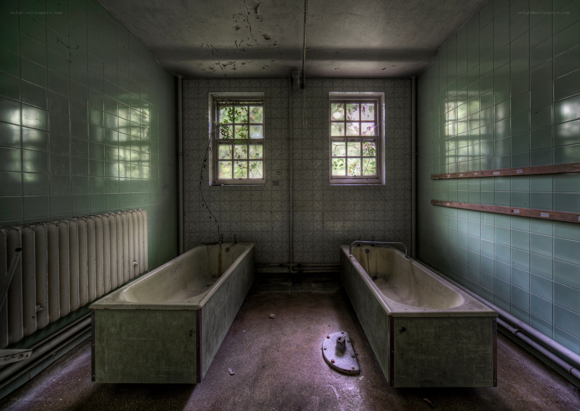 abandoned bathroom with two bathtubs