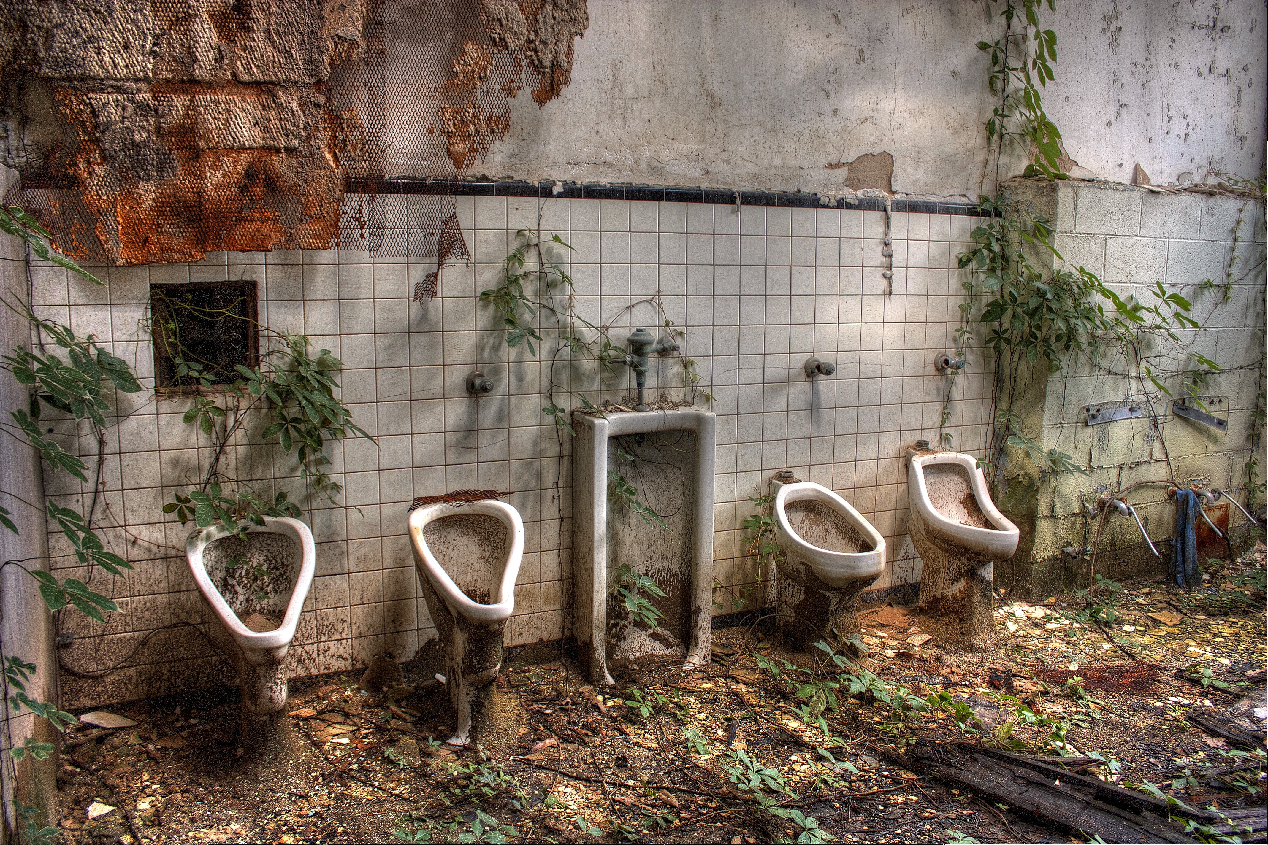 abandoned bathroom with urinals