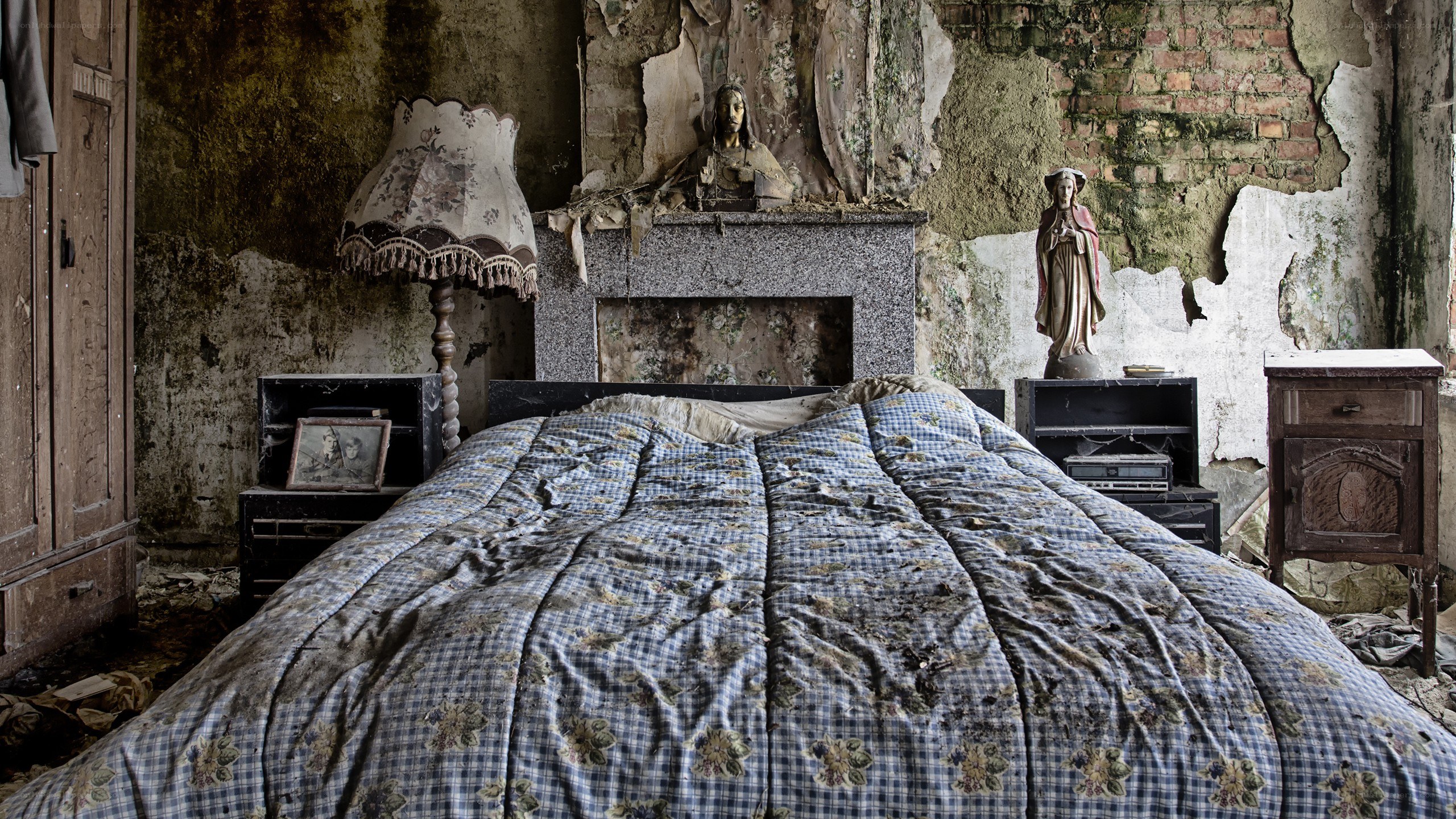 abandoned bedroom with religious statues