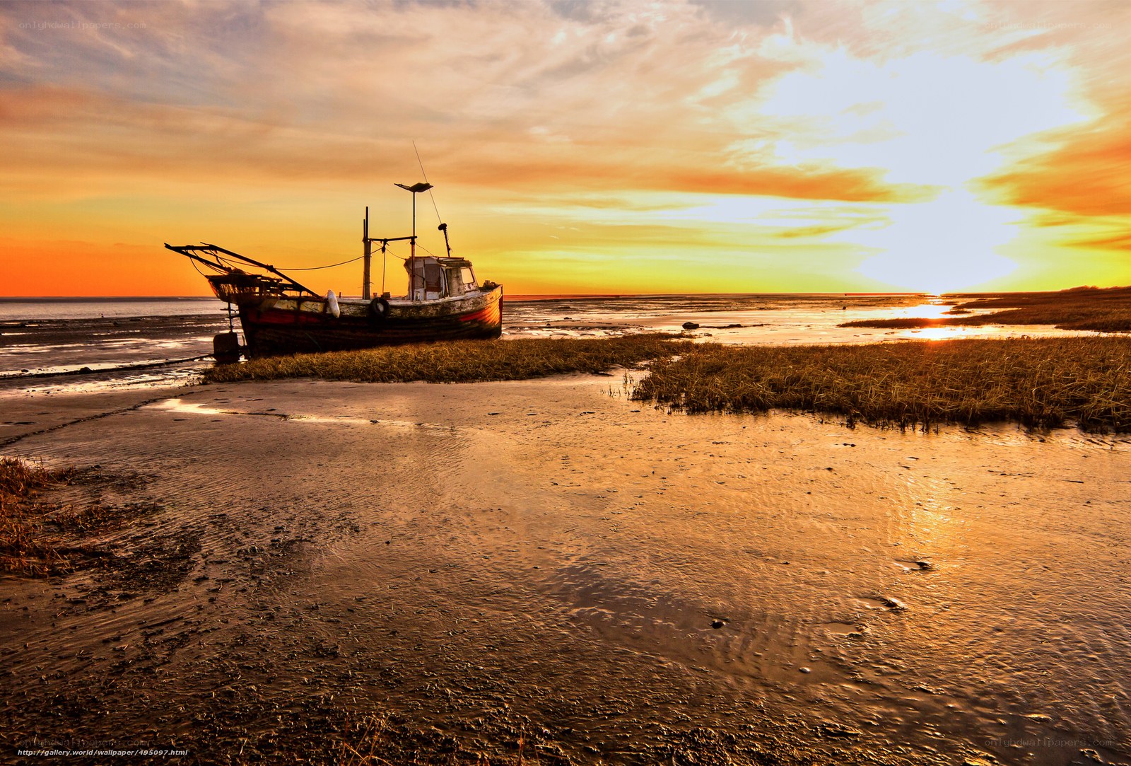 Abandoned boat at sunset