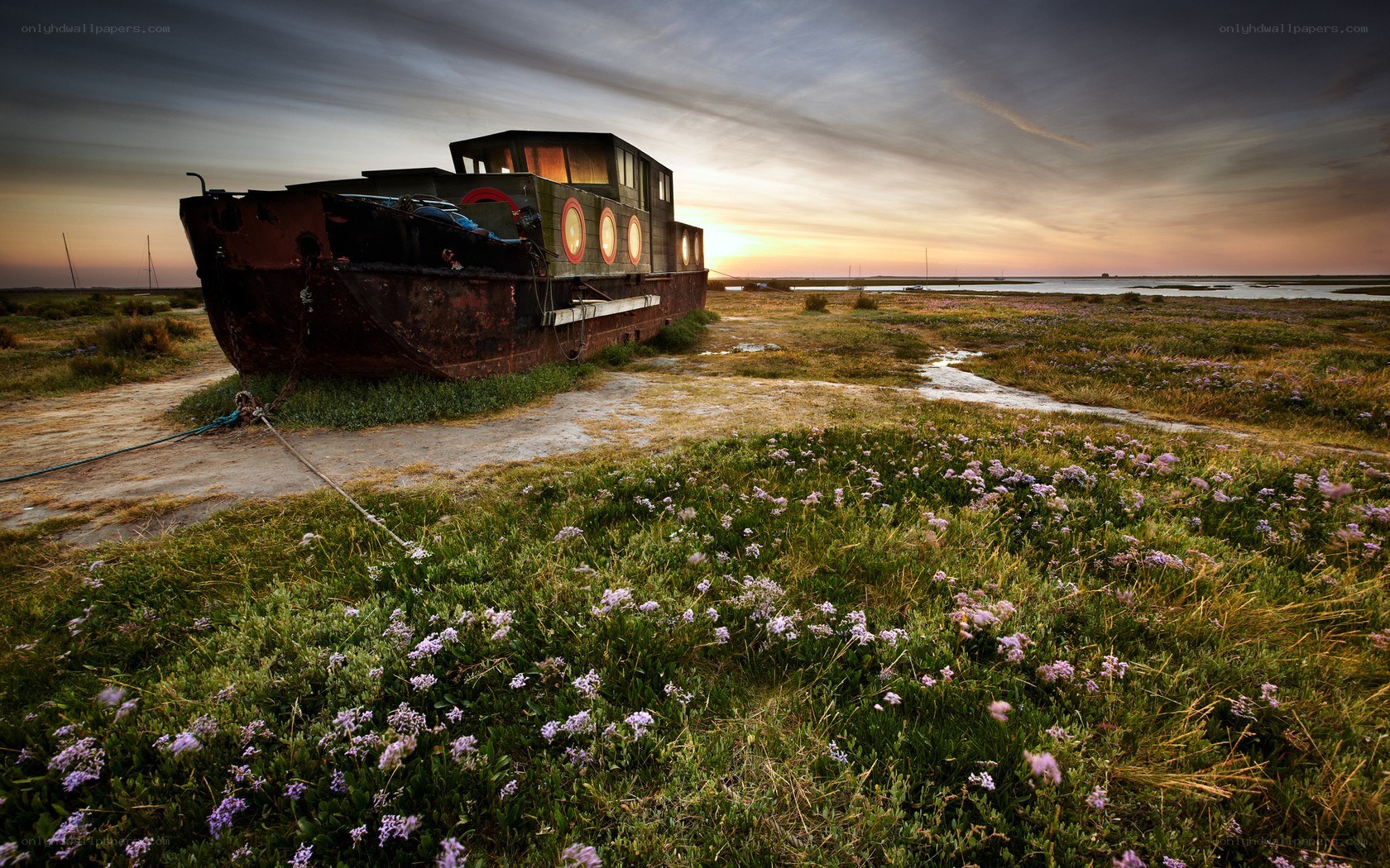 abandoned boat at sunset