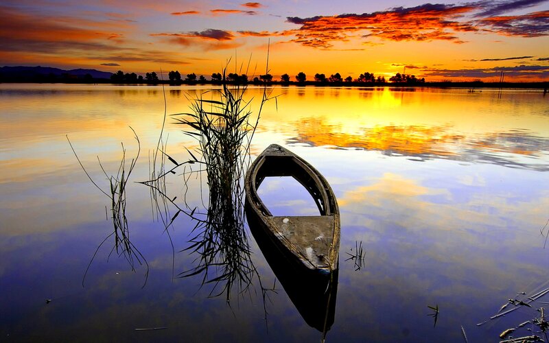 Abandoned Boat at Sunset — Orange, Serene