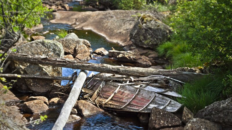 Abandoned boat in a stream