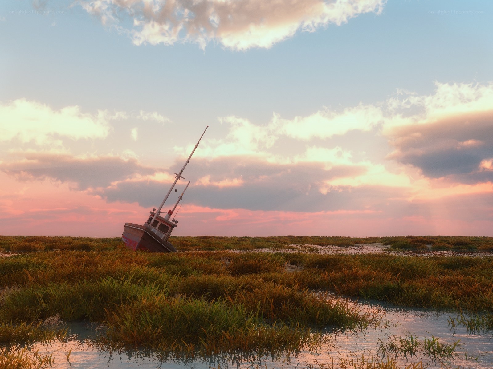 Abandoned boat in marsh at sunset