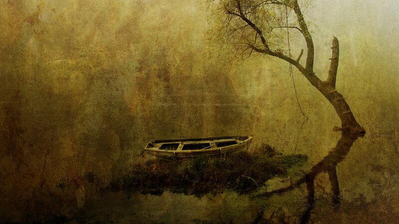 abandoned boat in misty water