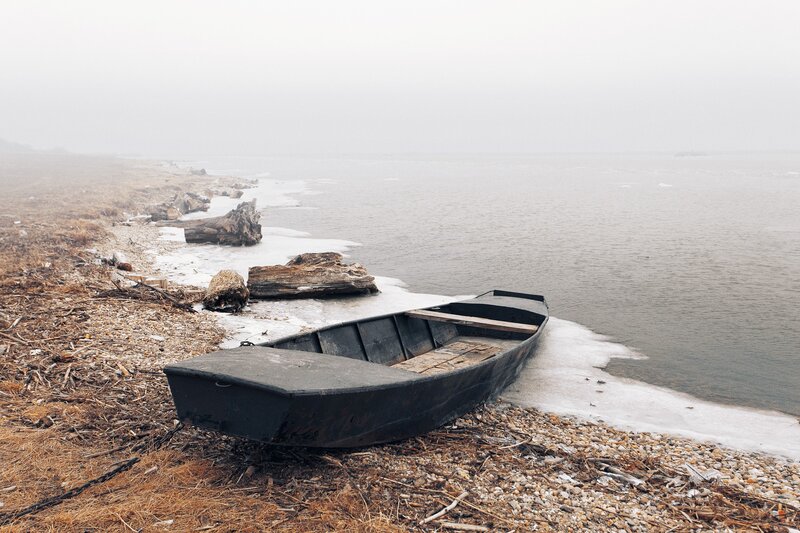 Abandoned boat on a foggy shore
