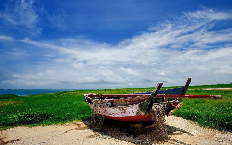 Abandoned boat on a grassy hill