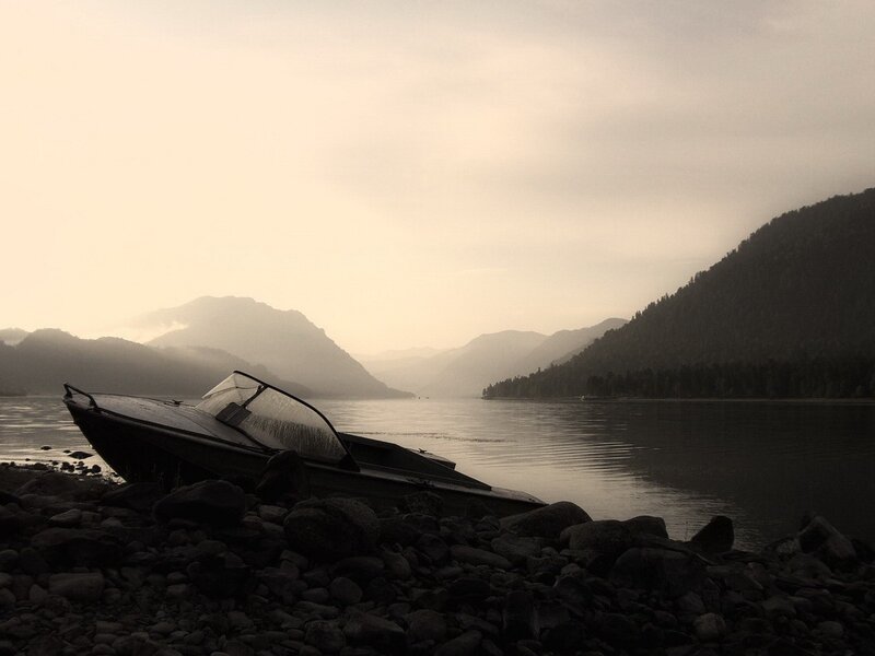 abandoned boat on a lake shore