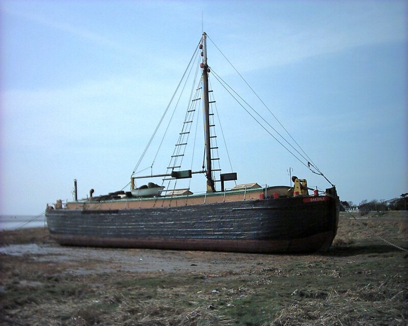 Abandoned boat on a muddy shore