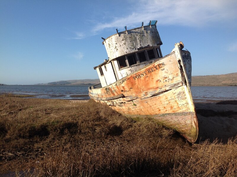 Abandoned boat on a muddy shore